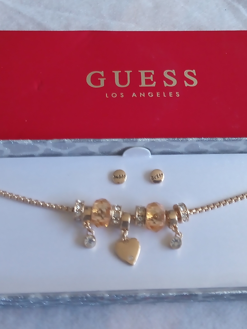 GUESS GOLD TONE CHARM BRACELET